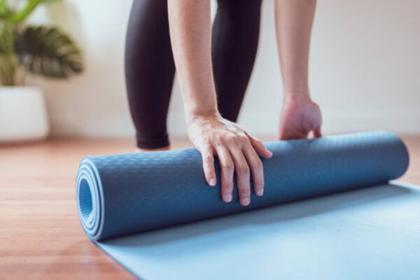 Yoga mat rolled out in a cozy living room
